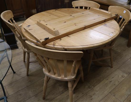 A pine extending dining table and four chairs, W.159cm fully extended with 1 leaf